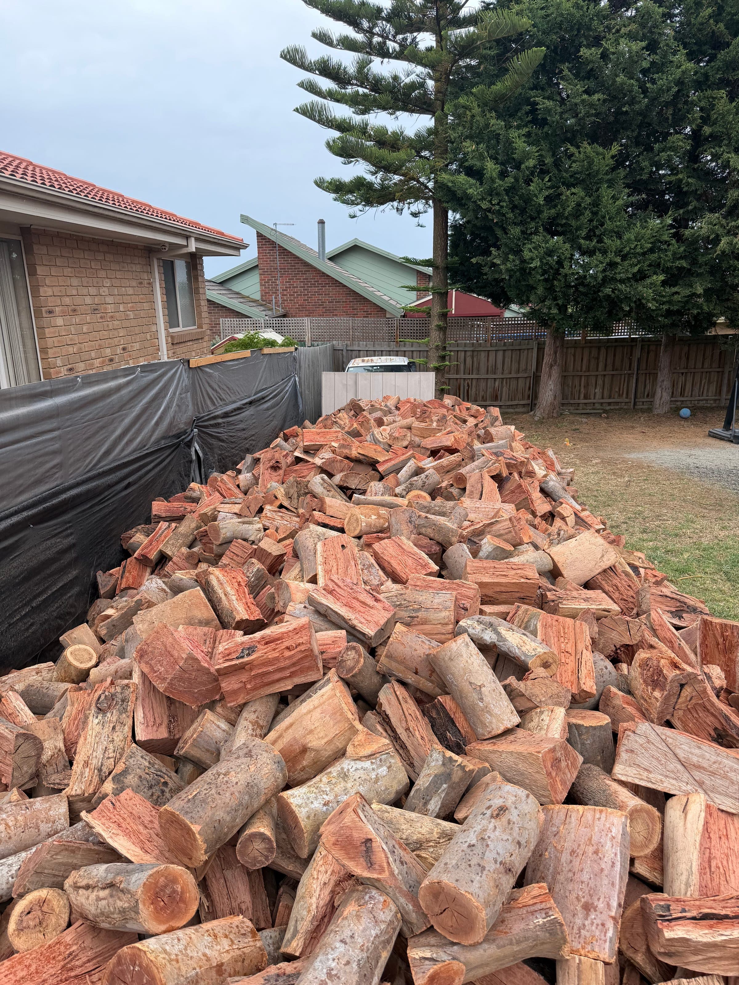 A large pile of split seasoned firewood stacked at the KDL yard