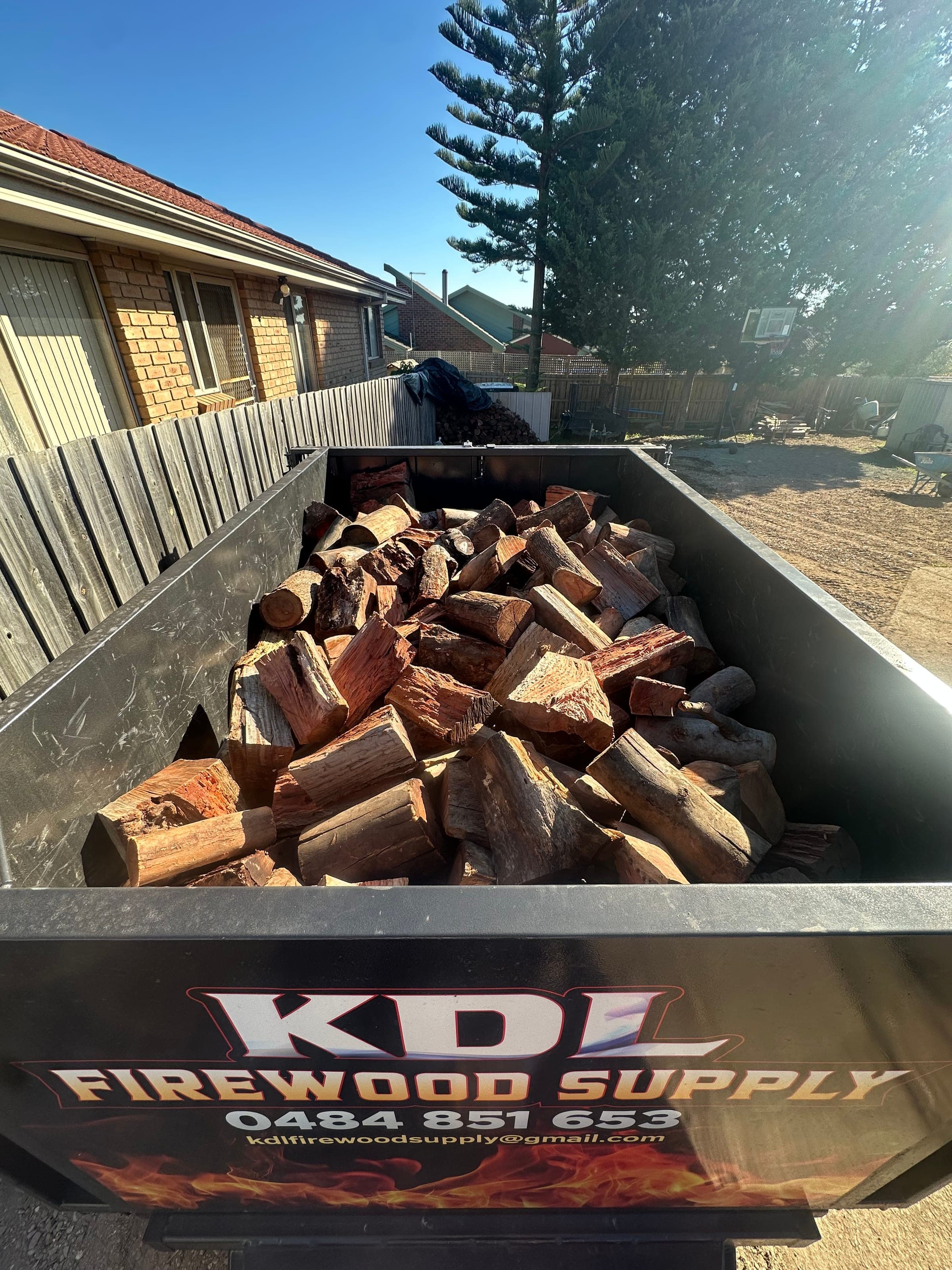 KDL Firewood Supply trailer loaded with split firewood, branded for delivery