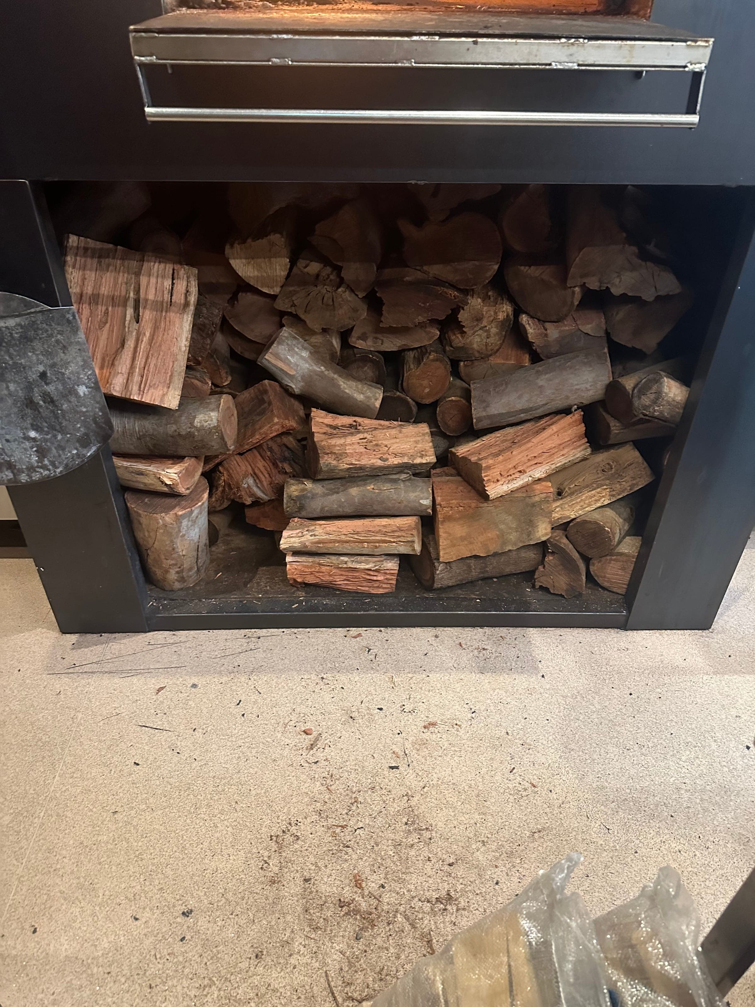 KDL firewood neatly stored in a customer's woodbox by their fireplace